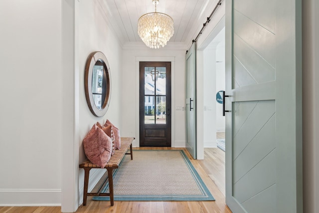 3894 Sawyers Island Dr, Mount Pleasant, SC 29466 - entrance foyer featuring ornamental molding, baseboards, a chandelier, a barn door, and light wood finished floors