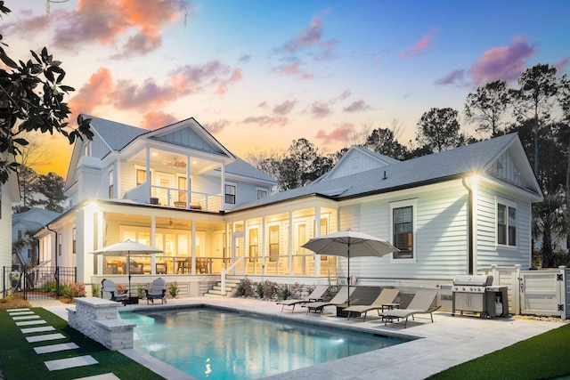 3894 Sawyers Island Dr, Mount Pleasant, SC 29466 - back of property with a balcony, fence, a patio, a fenced in pool, and board and batten siding