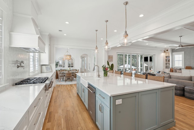 3894 Sawyers Island Dr, Mount Pleasant, SC 29466 - kitchen with decorative backsplash, crown molding, premium range hood, light wood-type flooring, and gray cabinetry