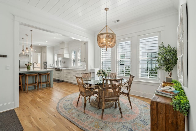 3894 Sawyers Island Dr, Mount Pleasant, SC 29466 - dining area featuring a healthy amount of sunlight, ornamental molding, a chandelier, and light wood-type flooring