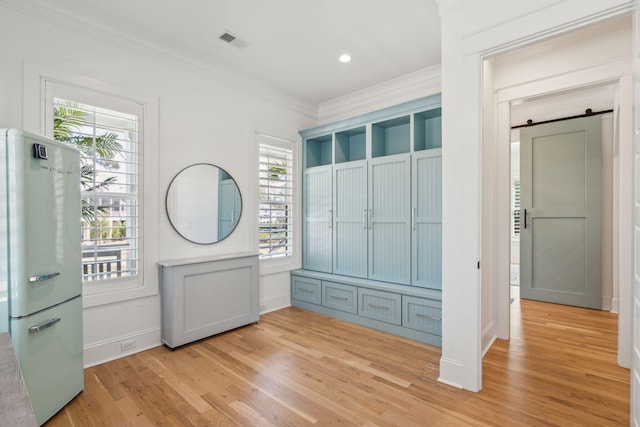 3894 Sawyers Island Dr, Mount Pleasant, SC 29466 - entrance foyer with ornamental molding, baseboards, a barn door, light wood-style floors, and visible vents