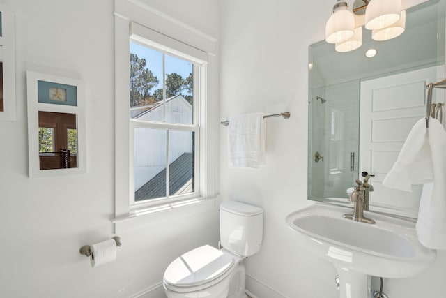 3894 Sawyers Island Dr, Mount Pleasant, SC 29466 - bathroom featuring a tile shower, toilet, a healthy amount of sunlight, and a sink