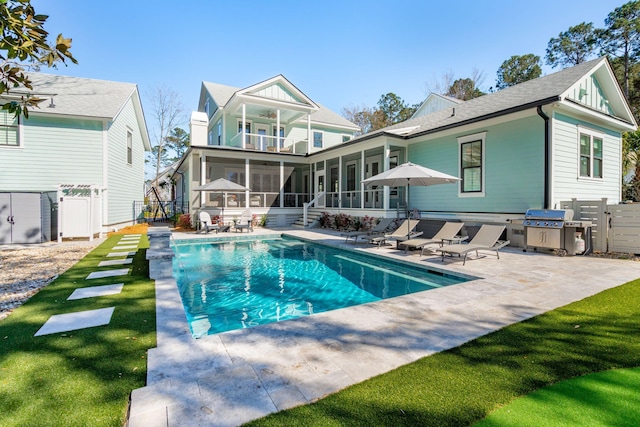3894 Sawyers Island Dr, Mount Pleasant, SC 29466 - rear view of house featuring a balcony, a sunroom, fence, an outdoor pool, and a patio