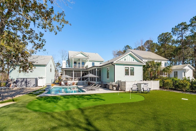3894 Sawyers Island Dr, Mount Pleasant, SC 29466 - rear view of property with a fenced in pool, a sunroom, a lawn, and a patio