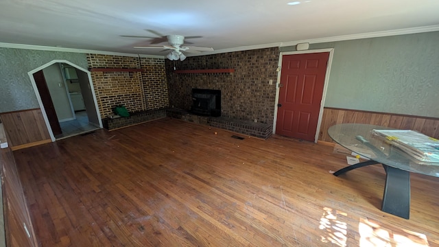116 Stillfield Dr, Moncks Corner, SC 29461 - unfurnished living room featuring a ceiling fan, a wainscoted wall, hardwood / wood-style flooring, wood walls, and a fireplace