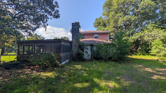 116 Stillfield Dr, Moncks Corner, SC 29461 - back of house with a sunroom, a chimney, and a lawn