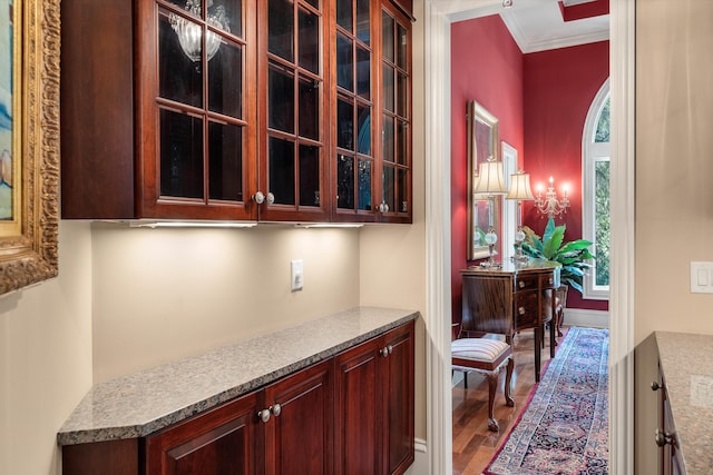 hall with wood-type flooring and ornamental molding