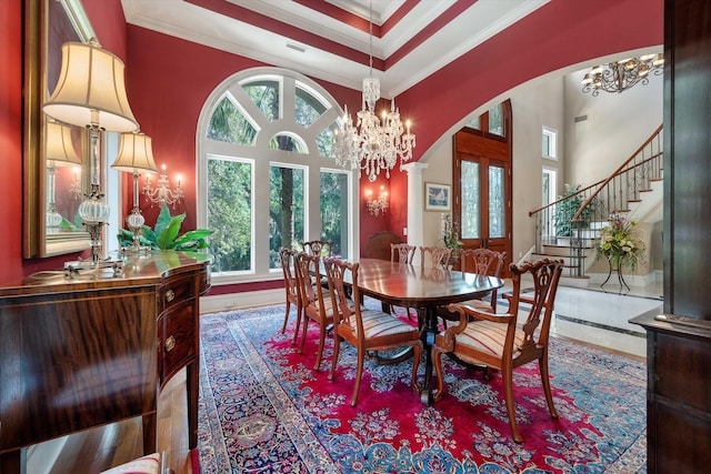 dining area with ornate columns, a wealth of natural light, french doors, and ornamental molding