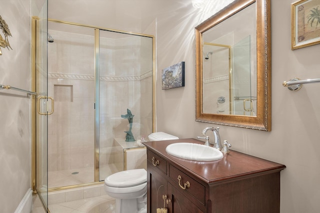 bathroom with tile patterned floors, vanity, toilet, and a shower with door