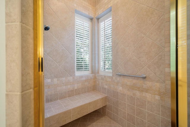 bathroom with plenty of natural light and a tile shower