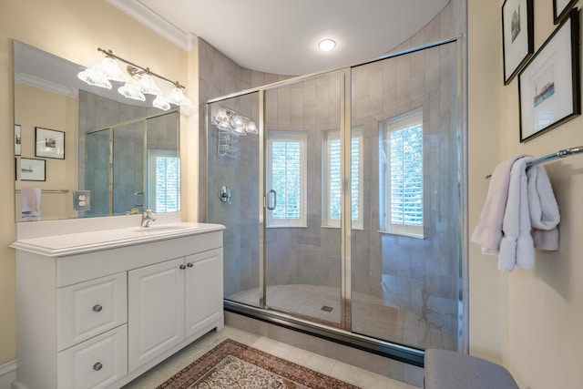 bathroom with tile patterned floors, vanity, and an enclosed shower