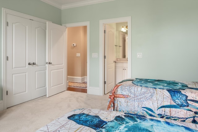 bedroom with carpet, connected bathroom, a closet, and crown molding