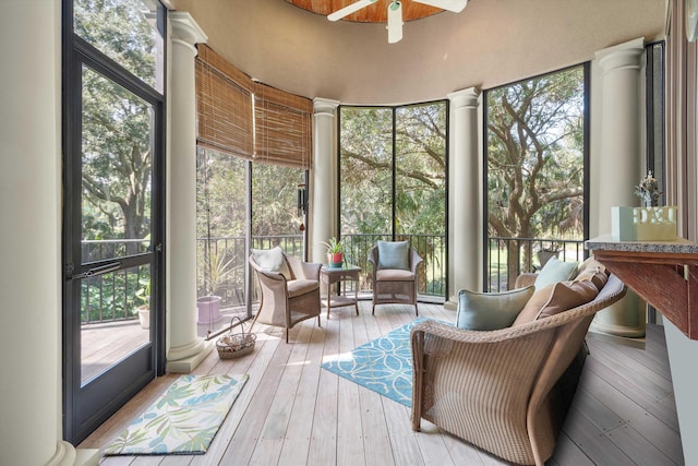 sunroom / solarium featuring decorative columns and ceiling fan