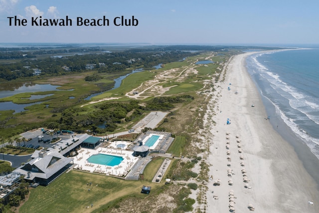 birds eye view of property featuring a water view and a beach view