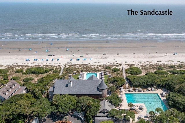 birds eye view of property with a beach view and a water view