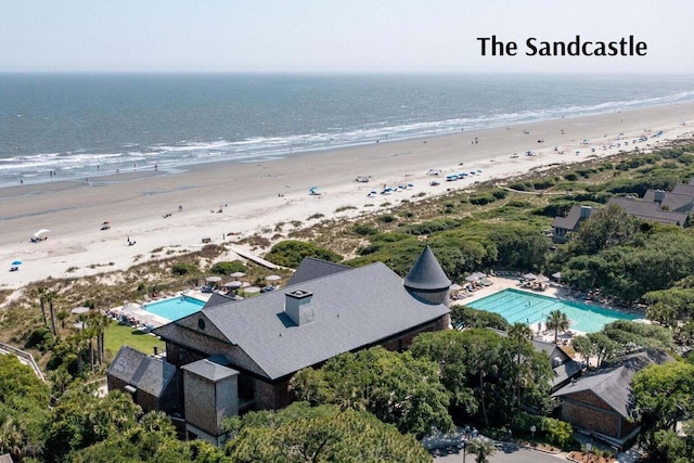 drone / aerial view featuring a beach view and a water view