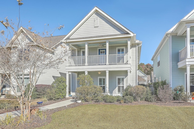 view of front facade with a balcony, covered porch, and a front yard