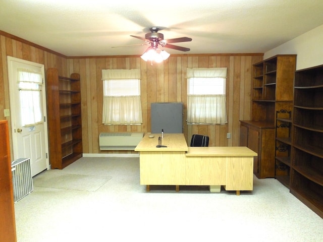 office area featuring ornamental molding, ceiling fan, wood walls, and radiator heating unit