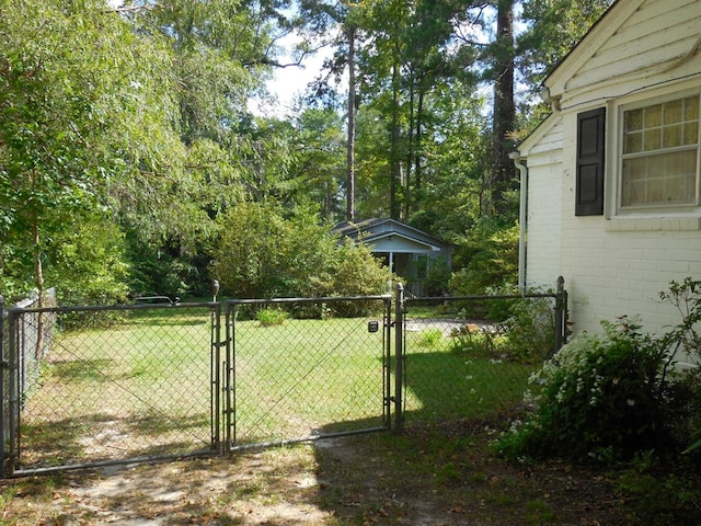 view of gate featuring a lawn