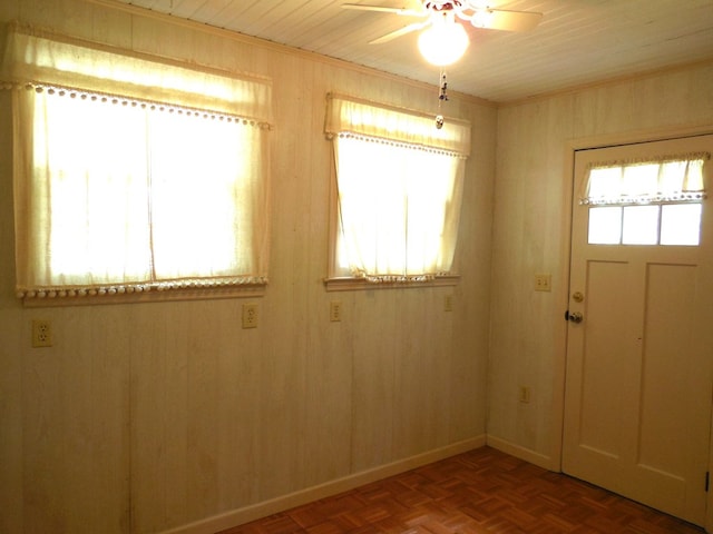 interior space featuring wood walls, parquet floors, wood ceiling, and ceiling fan