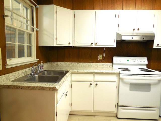 kitchen with sink, white electric stove, and white cabinets