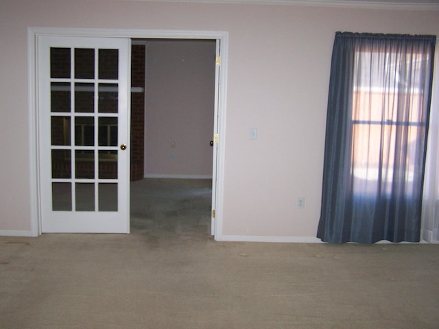 carpeted empty room featuring french doors