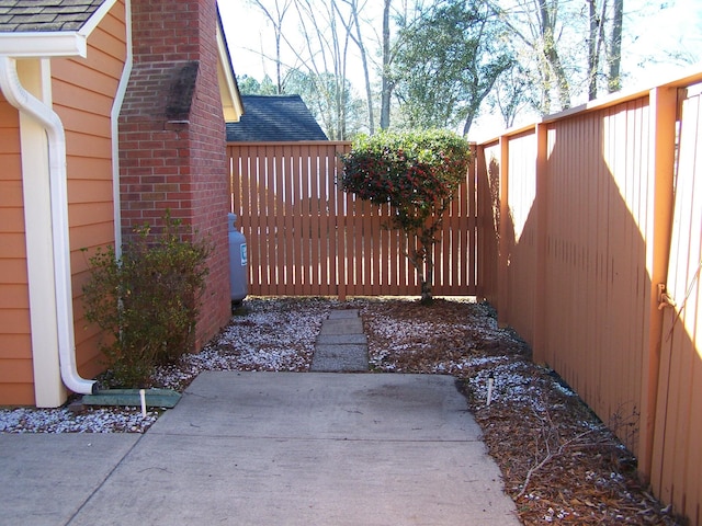 view of gate with a patio