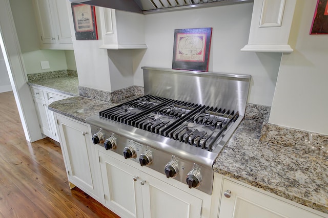 1 Vendue Range Range Unit I, Charleston, SC 29401 - kitchen featuring wood finished floors, stainless steel gas stovetop, white cabinetry, and light stone countertops