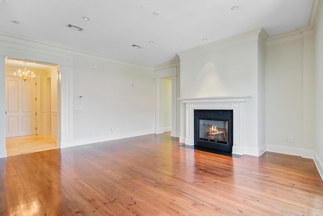 1 Vendue Range Range Unit I, Charleston, SC 29401 - unfurnished living room featuring ornamental molding, a chandelier, light wood-style floors, a fireplace with flush hearth, and baseboards
