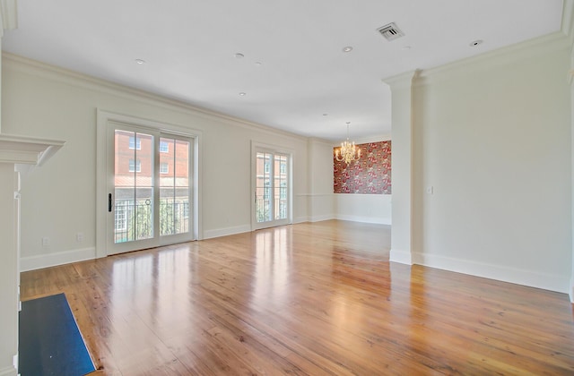1 Vendue Range Range Unit I, Charleston, SC 29401 - unfurnished living room featuring a chandelier, ornamental molding, light wood finished floors, and baseboards