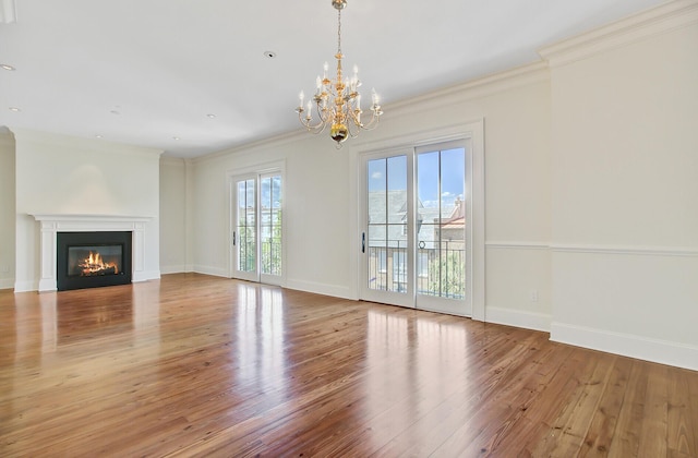 1 Vendue Range Range Unit I, Charleston, SC 29401 - unfurnished living room featuring a chandelier, wood finished floors, ornamental molding, a glass covered fireplace, and baseboards