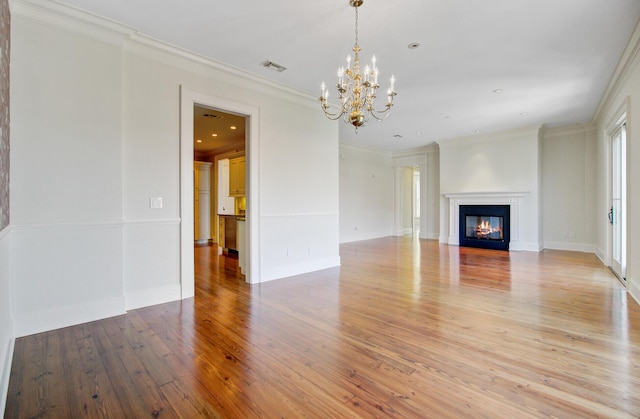 1 Vendue Range Range Unit I, Charleston, SC 29401 - unfurnished living room with a chandelier, light wood-type flooring, ornamental molding, a glass covered fireplace, and baseboards