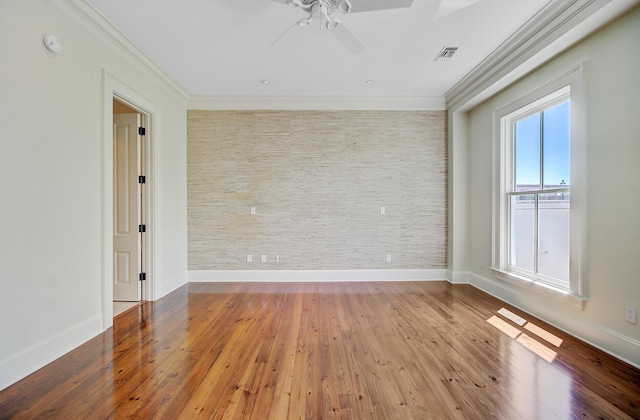 1 Vendue Range Range Unit I, Charleston, SC 29401 - spare room featuring crown molding, ceiling fan, baseboards, wood finished floors, and an accent wall