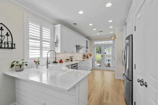 kitchen featuring white cabinets, recessed lighting, crown molding, and appliances with stainless steel finishes