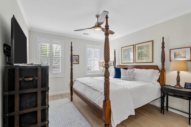 bedroom with light wood-style floors, visible vents, baseboards, and crown molding