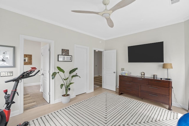 bedroom with ceiling fan, light wood finished floors, baseboards, and ornamental molding