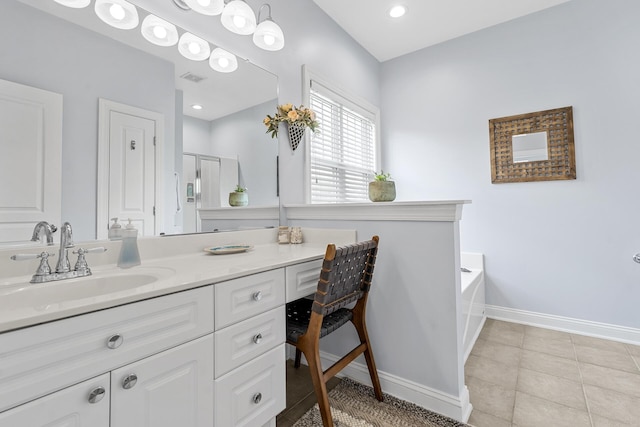 full bathroom featuring visible vents, a bath, baseboards, vanity, and tile patterned flooring
