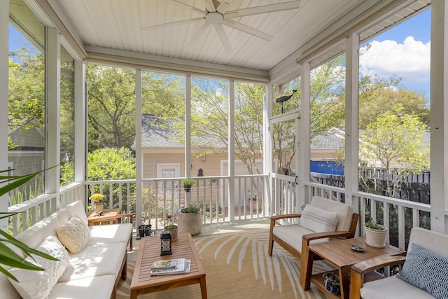 sunroom featuring ceiling fan, plenty of natural light, and an outdoor hangout area