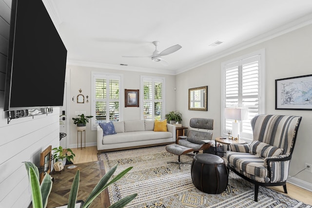 living room with crown molding, baseboards, and wood finished floors