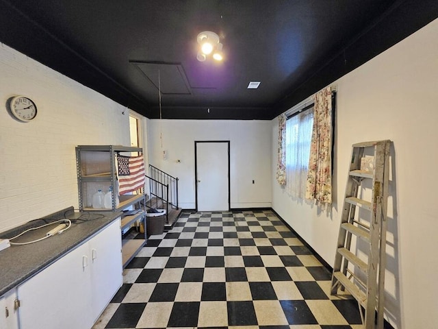 kitchen featuring dark floors, dark countertops, and white cabinets