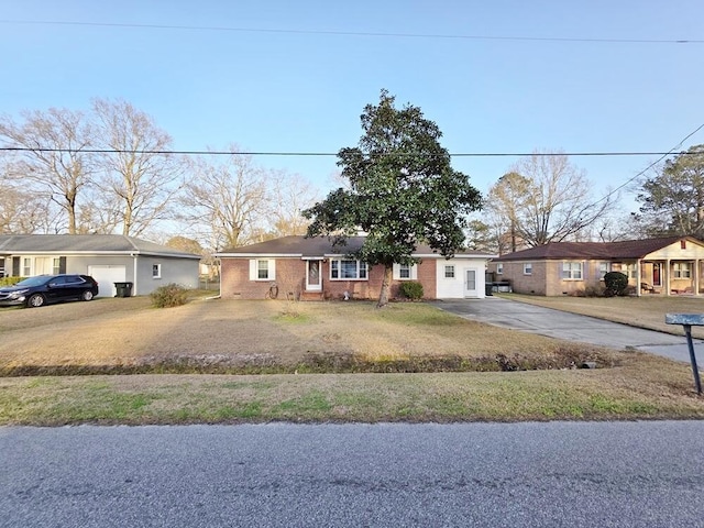 ranch-style house featuring driveway, a front yard, and brick siding