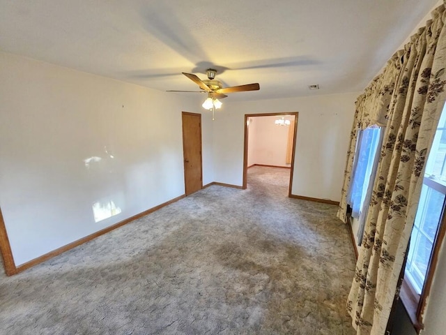 unfurnished bedroom featuring carpet floors, visible vents, ceiling fan, and baseboards