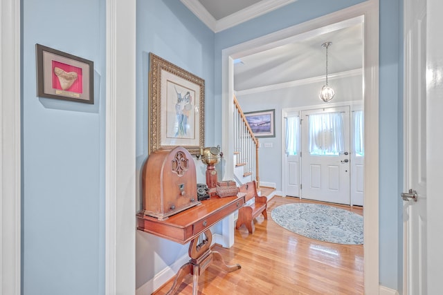 entrance foyer featuring hardwood / wood-style flooring and crown molding