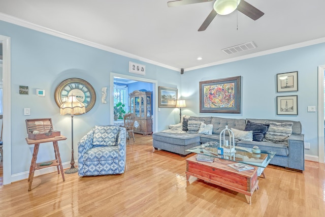 living room featuring light hardwood / wood-style flooring, ceiling fan, and ornamental molding