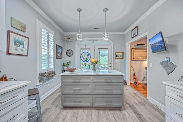 bathroom featuring crown molding, hardwood / wood-style floors, and vanity