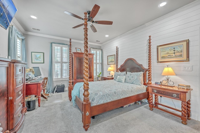 carpeted bedroom featuring ornamental molding, ceiling fan, and wooden walls