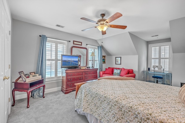 carpeted bedroom with multiple windows, vaulted ceiling, and ceiling fan