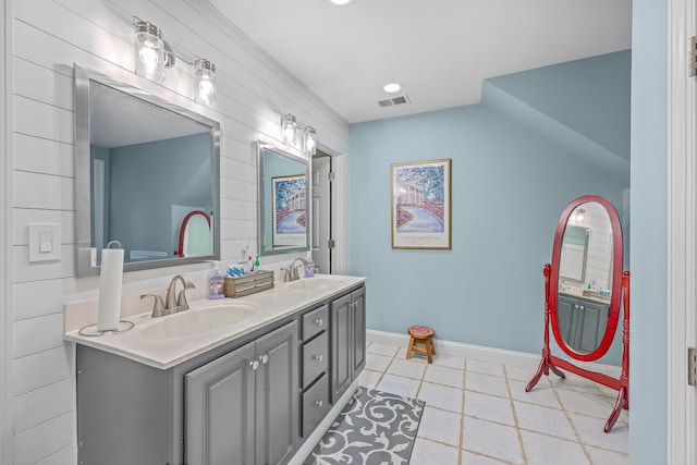 bathroom featuring tile patterned floors, lofted ceiling, and vanity