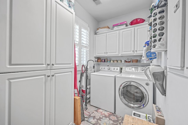 laundry area with washer and clothes dryer and cabinets