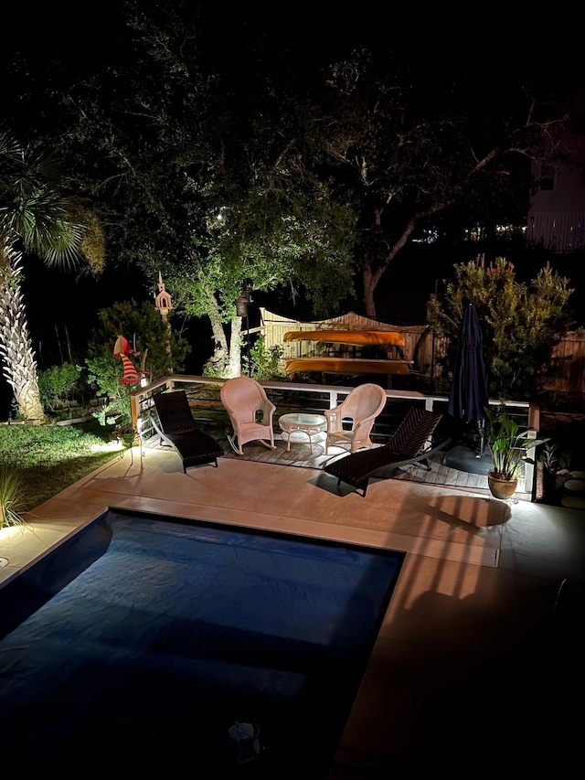 pool at night with a patio